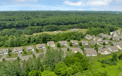 Stunning aerial view showcasing a desirable neighborhood surrounded by lush greenery and scenic river views.