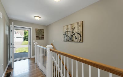 Bright entryway featuring a welcoming atmosphere and modern design, leading to a spacious living area.