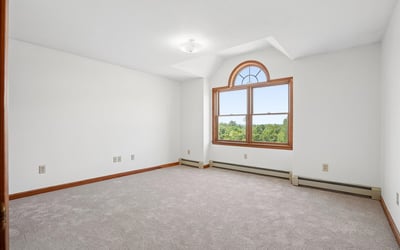 Spacious room featuring large window with scenic views, perfect for customization to your taste.