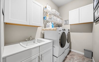 Laundry room off of the entry and walks through to primary suite.