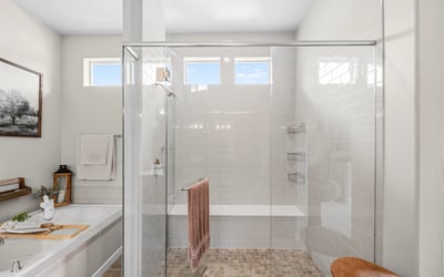 Primary Suite with attached 5 piece bath and walk in closet.