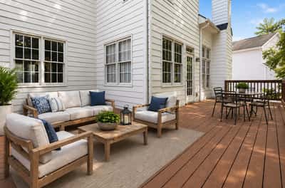 Enjoy outdoor living on this spacious deck, perfect for gatherings or relaxing evenings under the sky. (Virtual Staging)