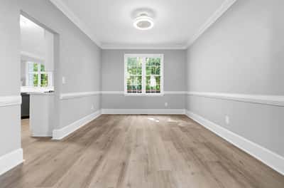 Bright, versatile dining room featuring modern finishes and ample natural light, perfect for various living arrangements.