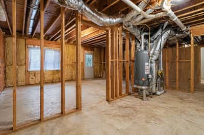Spacious, unfinished basement offers endless possibilities for customization and improvement.