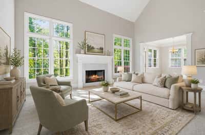 Bright and inviting living room featuring large windows, a cozy fireplace, and modern furnishings for comfort. (Virtual Staging)