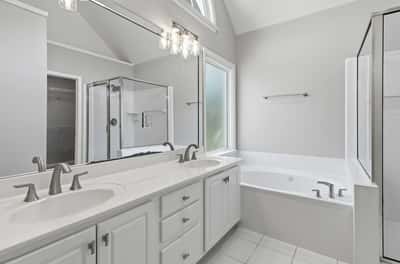 Spacious master bathroom with updated lighting and fixtures