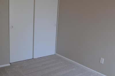 Inviting bedroom with fresh carpeting, ample closet storage, neutral paint, and a ceiling fan. This move-in-ready room offers comfort and versatility for a variety of lifestyles.