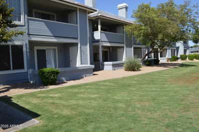 Attractive community grounds featuring lush green lawns, mature trees, and professionally maintained landscaping. The inviting outdoor setting adds to the appeal and lifestyle of this Phoenix home.