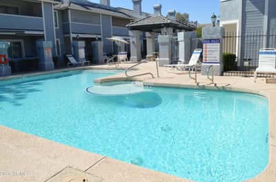 Expansive community swimming pool with shallow entry, surrounding sundeck, and comfortable poolside seating. This impressive amenity adds everyday convenience and enjoyment to life in this desirable Phoenix community.