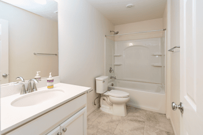 Well-maintained bathroom features a bathtub, modern fixtures, and a spacious vanity for convenience.
