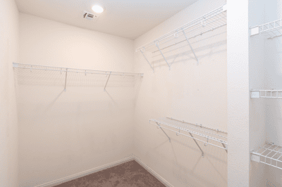 Spacious walk-in closet featuring ample shelving for organized storage and easy accessibility.