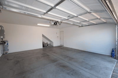 Spacious garage featuring clean, open space ideal for storage or vehicle parking, with direct access to the home.