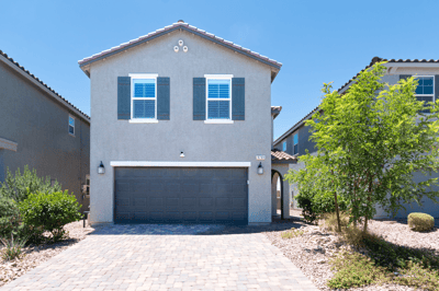 Modern home with a spacious driveway and attractive landscaping, conveniently located in a desirable neighborhood.