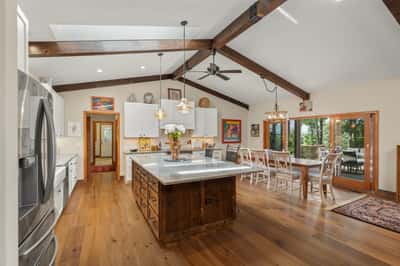 This spacious kitchen features a large island, vaulted ceilings, and abundant natural light for dining and entertaining.