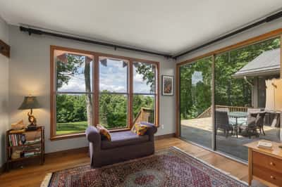 Bright, airy living space features expansive windows offering stunning views and seamless outdoor access.