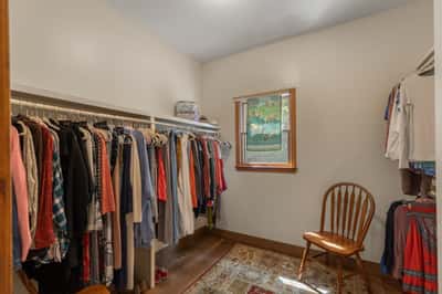 Spacious walk-in closet featuring ample storage and natural light from a nearby window.
