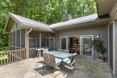 Spacious outdoor patio ideal for entertaining, surrounded by lush greenery and natural light.