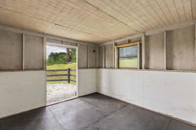 Spacious interior with potential for customization, featuring a door leading to scenic outdoor views.