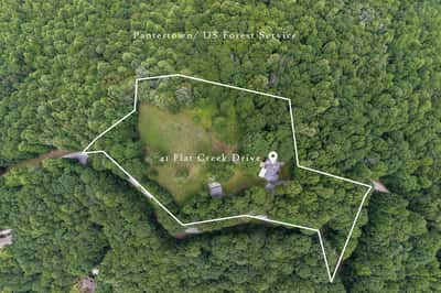 Discover this unique property nestled in lush greenery, offering ample space for outdoor adventures and privacy.