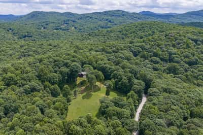 Discover this expansive, wooded retreat, perfect for secluded living or creating your dream escape.