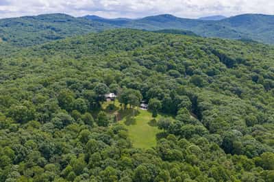 Secluded property on expansive wooded land, offering breathtaking mountain views and abundant outdoor space.