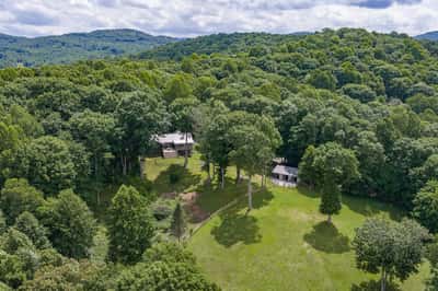 Discover a peaceful retreat surrounded by lush greenery and stunning mountain views, perfect for relaxing living.