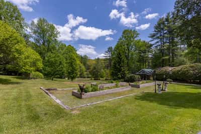 Expansive outdoor space featuring lush greenery and a tranquil garden area, perfect for relaxation and gatherings.
