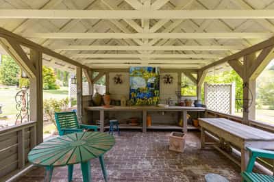Spacious outdoor pavilion with artwork, ideal for gatherings and enjoying nature's beauty in a private setting.