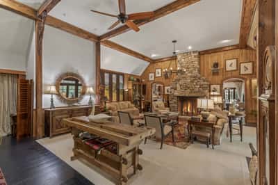 Spacious great room featuring a stunning stone fireplace and wood accents, perfect for entertaining and relaxation.