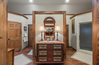 This inviting bathroom features rustic wooden accents and ample natural light, enhancing its welcoming atmosphere.