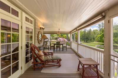 Spacious porch featuring comfortable seating and scenic views, perfect for relaxing and entertaining outdoors.