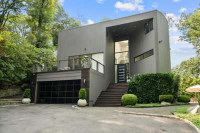 Contemporary home featuring open spaces and abundant natural light, surrounded by lush greenery and scenic views.