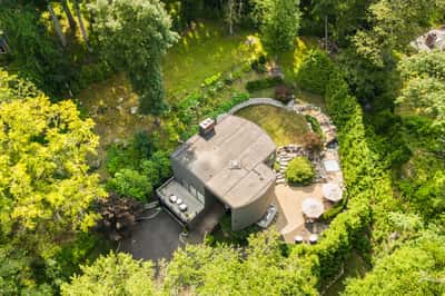 Nestled among lush greenery, this unique home features a private garden and spacious outdoor entertaining areas.