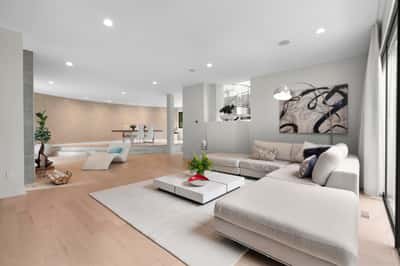 Spacious, contemporary living area featuring abundant natural light and modern design elements throughout.