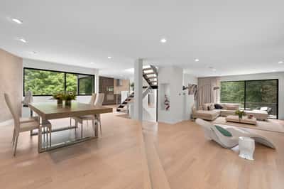 Bright and spacious open-concept living area with large windows and modern finishes, perfect for entertaining.