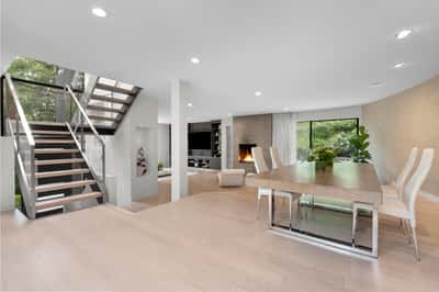 Spacious open floor plan features natural light, contemporary design, and a cozy fireplace for gatherings.
