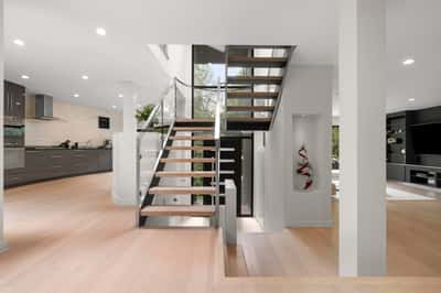 This modern home features a bright, open layout with sleek finishes and a stunning staircase.