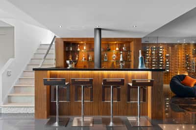 Modern basement bar featuring sleek seating and a sophisticated wine display, perfect for entertaining guests.
