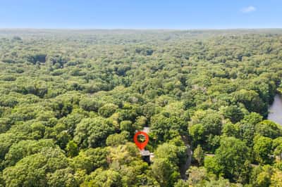 Discover this secluded retreat surrounded by lush greenery and tranquil waterways, perfect for nature enthusiasts.