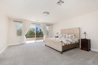 Primary Bedroom with walk-out slider to extended balcony with mountain views