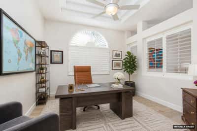 Downstairs office with double door entry and plantation shutters open to living room