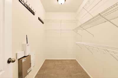 Spacious walk-in closet featuring ample shelving and organizational options for your clothing and accessories.