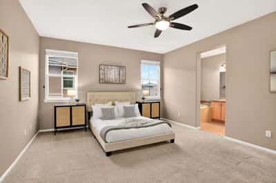 Spacious bedroom with natural light, featuring a comfortable bed and an en-suite bathroom for convenience.