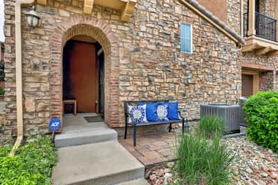 Discover a welcoming entrance with natural stone features and comfortable outdoor seating for relaxation.