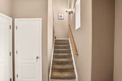 Bright and open staircase leads to spacious upper-level living, enhancing the home's inviting atmosphere.
