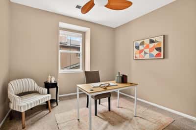 Bright and inviting home office space featuring natural light, modern furnishings, and a cozy atmosphere.