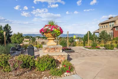 Discover a vibrant outdoor space featuring striking floral arrangements and breathtaking mountain views, perfect for relaxation.