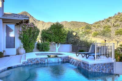 Relax in an elevated spa with panoramic Scottsdale mountain views, surrounded by peaceful desert landscaping and luxury outdoor living.