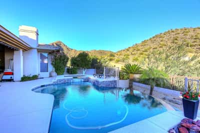 Resort-style pool with raised spa and water features creates a stunning Scottsdale backyard perfect for entertaining and relaxation.