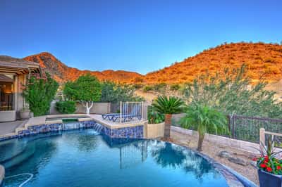 Vibrant sunset over the mountains creates a breathtaking Scottsdale backdrop, perfect for relaxing evenings and entertaining.